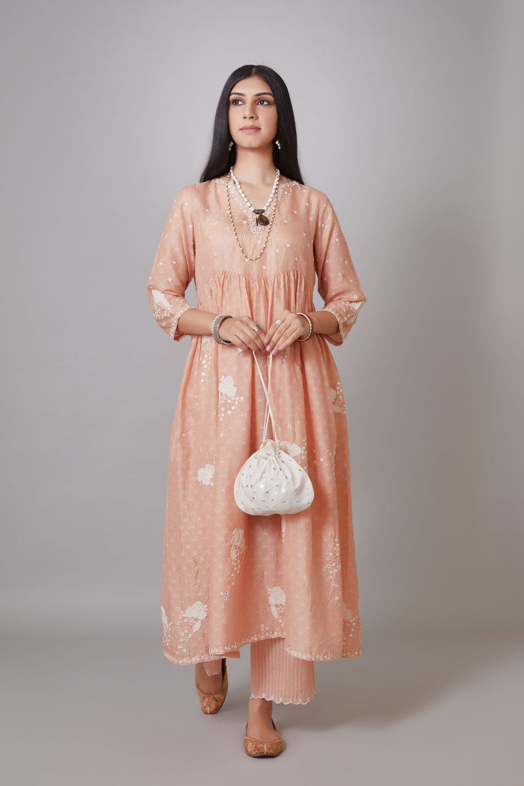 Hand block printed crushed silk kurta set with wavy empire waistline and gathers, highlighted with applique flower embroidery and mirror hand work.