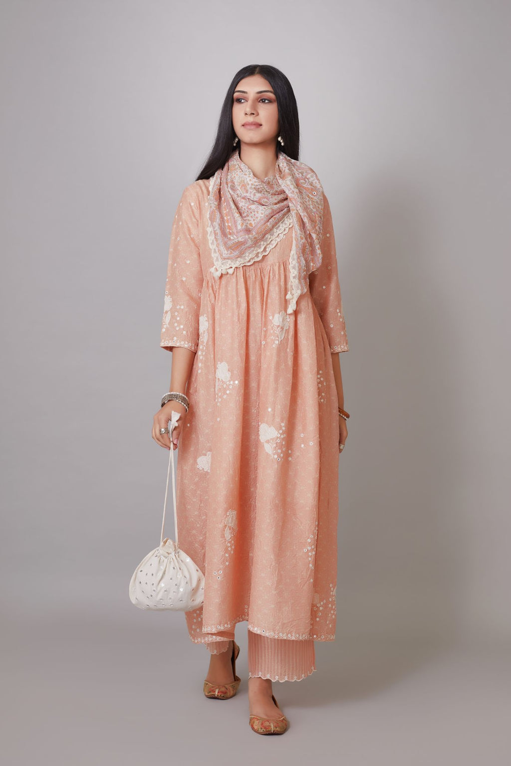 Hand block printed crushed silk kurta set with wavy empire waistline and gathers, highlighted with applique flower embroidery and mirror hand work.