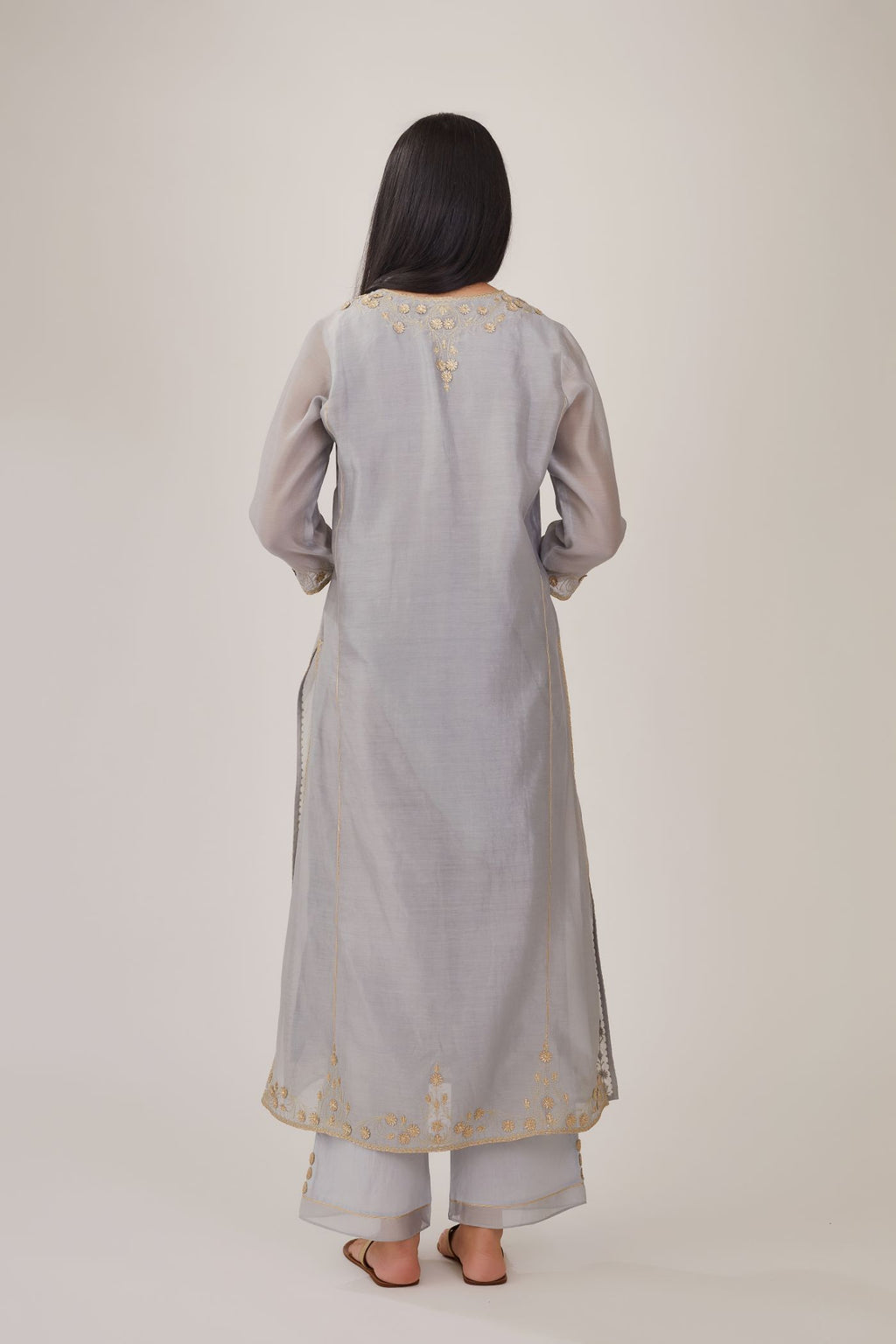 Steel blue silk chanderi kurta with gota embroidered neckline and hem, paired with steel blue straight pants with gota and silk chanderi fabric detaling at bottom hem