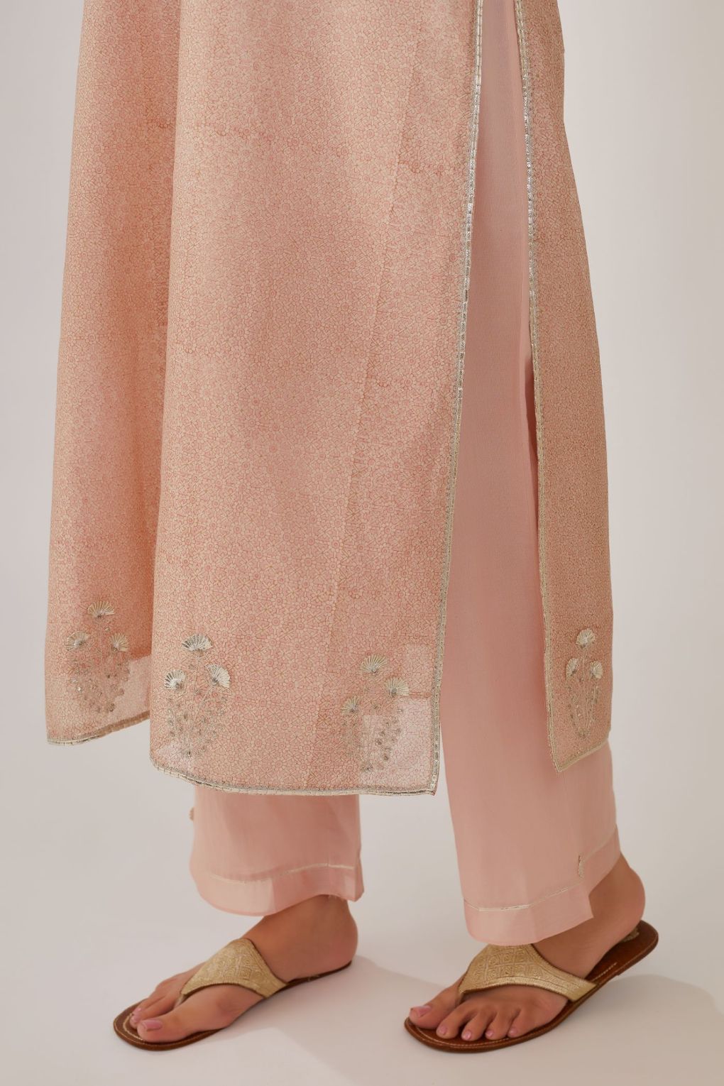 Pink hand block printed silk chanderi kurta with silver gota embroidery, paired with pink straight pants with gota and silk chanderi fabric detaling at bottom hem
