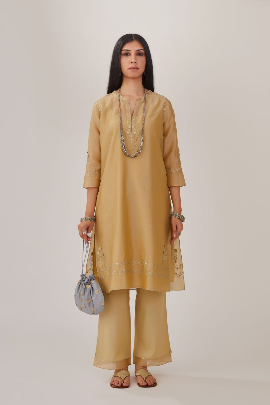 Olive silk chanderi short kurta detailed with gota embroidery and highlighted with bugle beads and sequins, paired with olive straight pants with gota and silk chanderi fabric detaling at bottom hem