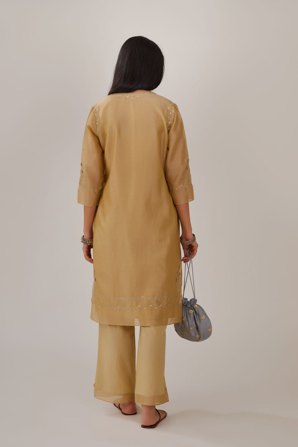 Olive silk chanderi short kurta detailed with gota embroidery and highlighted with bugle beads and sequins, paired with olive straight pants with gota and silk chanderi fabric detaling at bottom hem