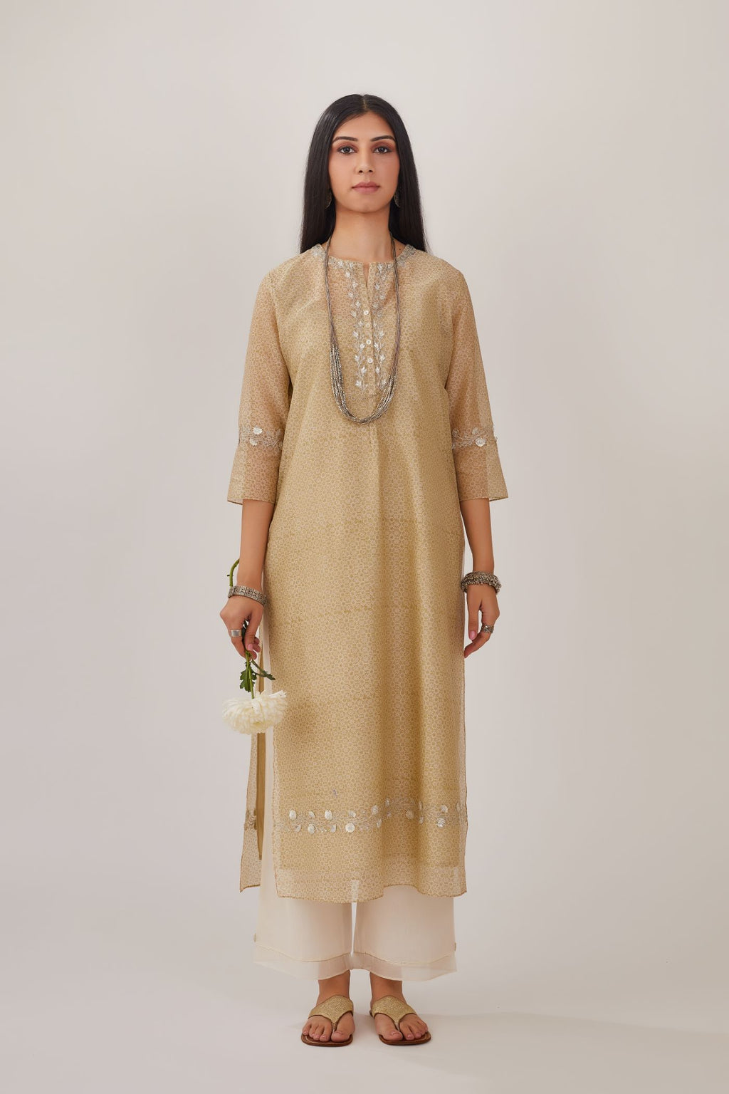 Olive hand block printed silk chanderi straight kurta highlighted with silver gota embroidery, paired with off white straight pants with gota and silk chanderi fabric detaling at bottom hem