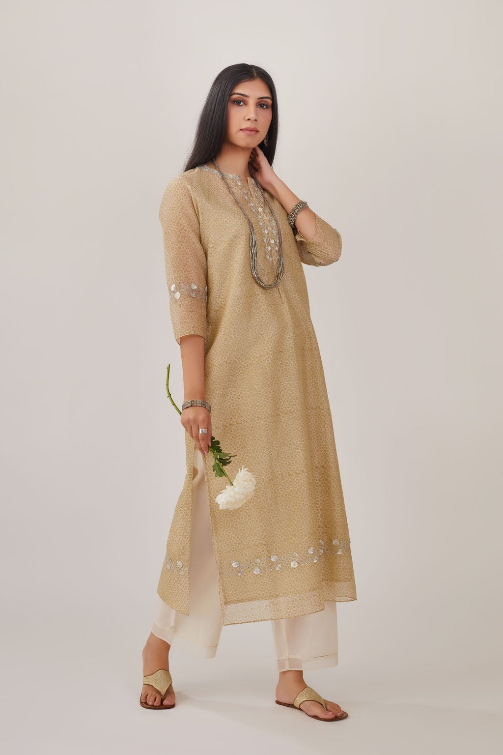 Olive hand block printed silk chanderi straight kurta highlighted with silver gota embroidery, paired with off white straight pants with gota and silk chanderi fabric detaling at bottom hem