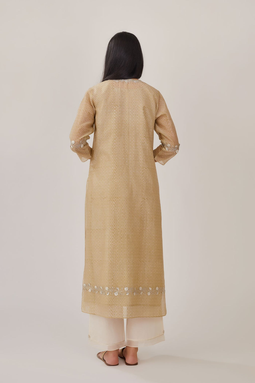 Olive hand block printed silk chanderi straight kurta highlighted with silver gota embroidery, paired with off white straight pants with gota and silk chanderi fabric detaling at bottom hem