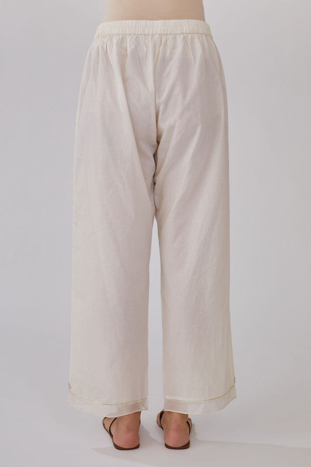 Off white straight pants with gota and silk chanderi fabric detaling at bottom hem