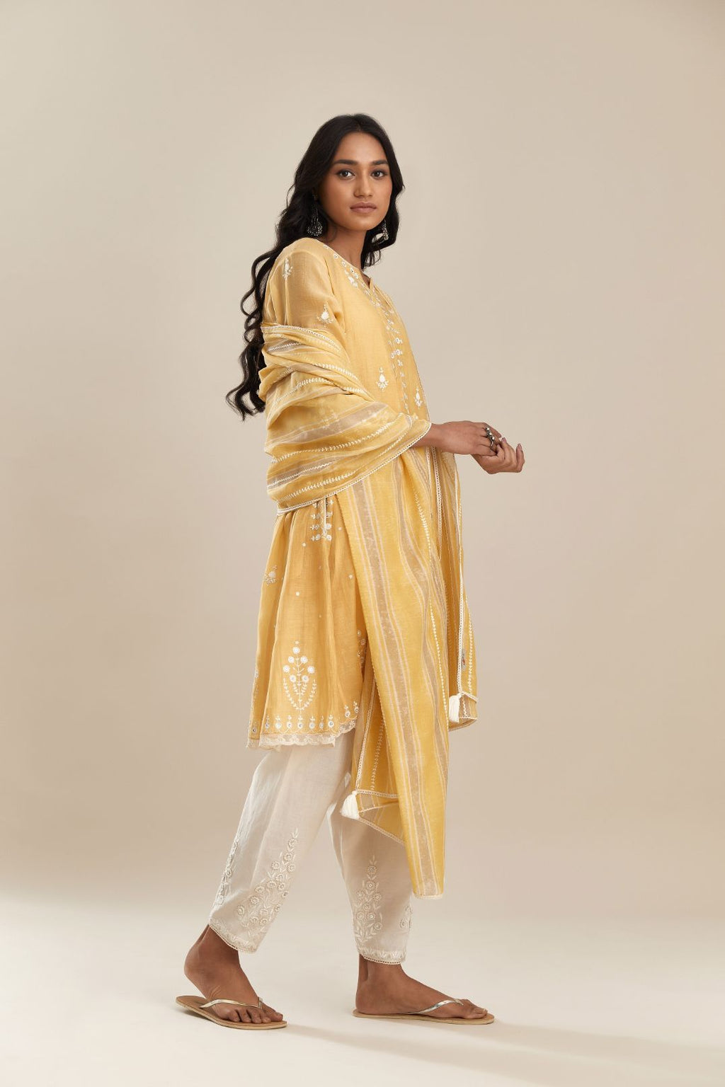 Yellow cotton chanderi short kalidar kurta set, with off white silk thread embroidery, highlighted with hand attached sequin and beads.