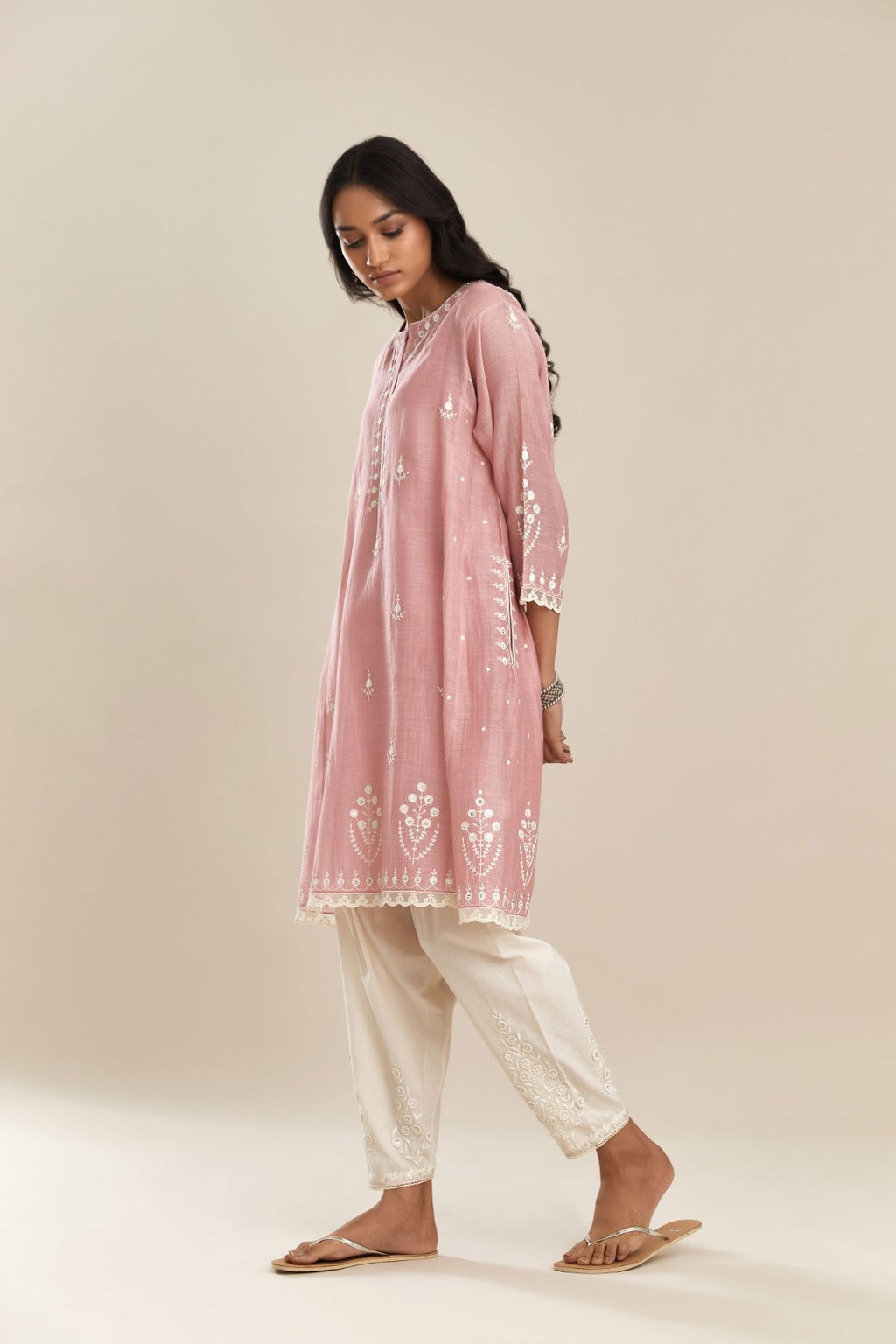 Pink cotton chanderi short kalidar kurta set, with off white silk thread embroidery, highlighted with hand attached sequin and beads.