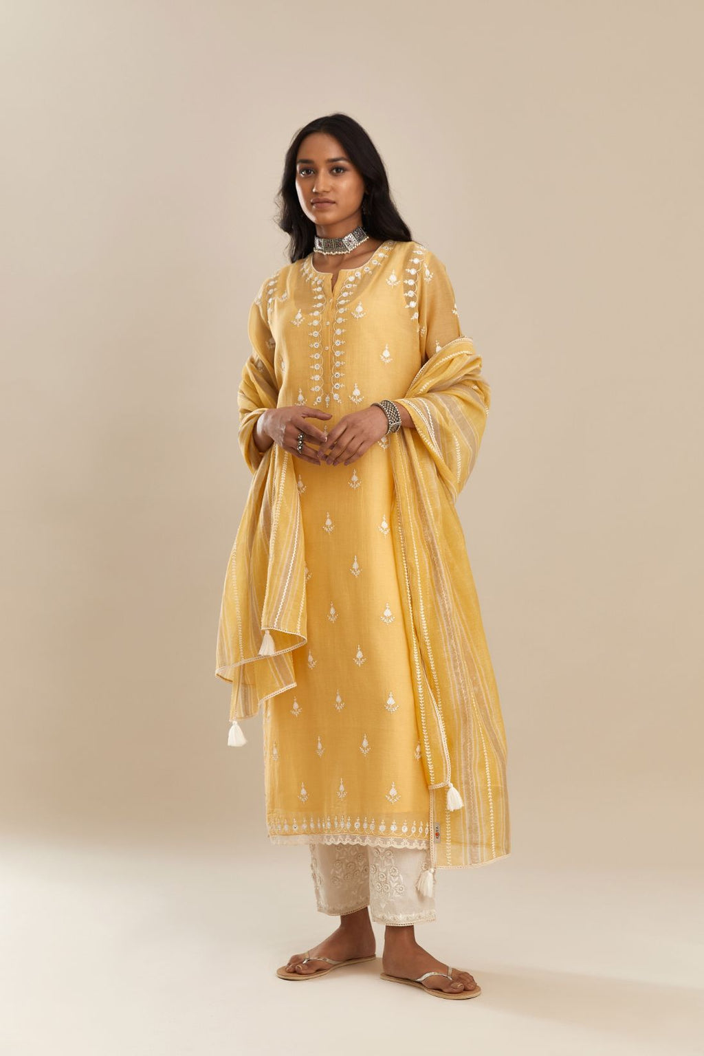 Yellow cotton chanderi straight kurta set with all-over off white silk thread embroidery, highlighted with hand attached sequin and beads.
