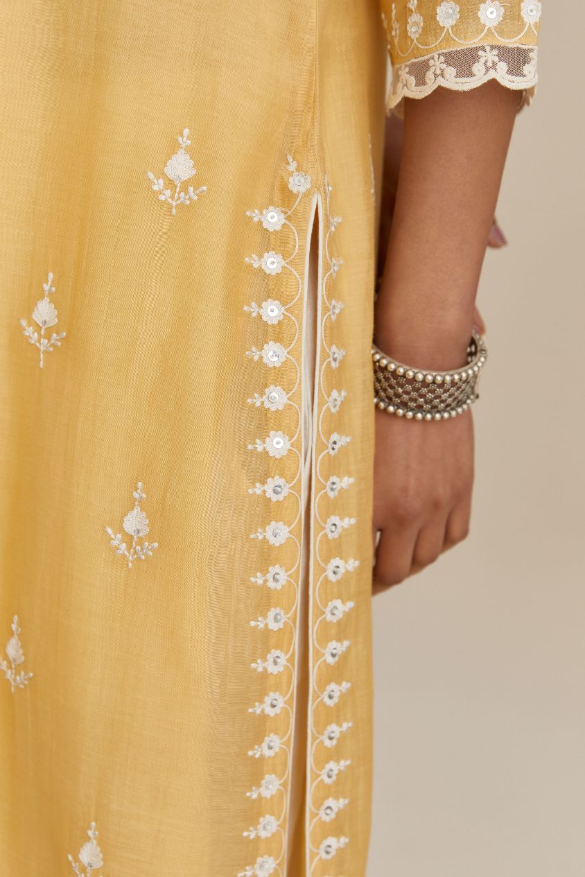 Yellow cotton chanderi straight kurta set with all-over off white silk thread embroidery, highlighted with hand attached sequin and beads.