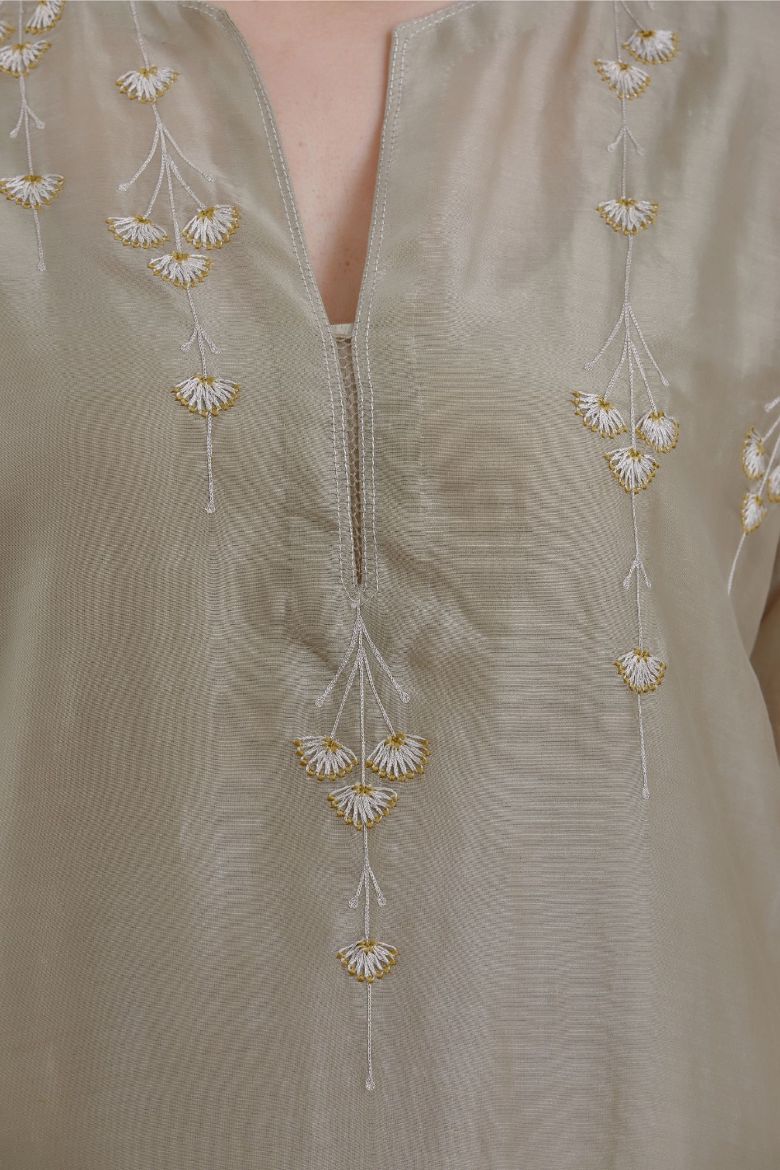 Silk Chanderi straight kurta set detailed with silver zari and contrasting thread embroidery, highlighted with silver zari quilting