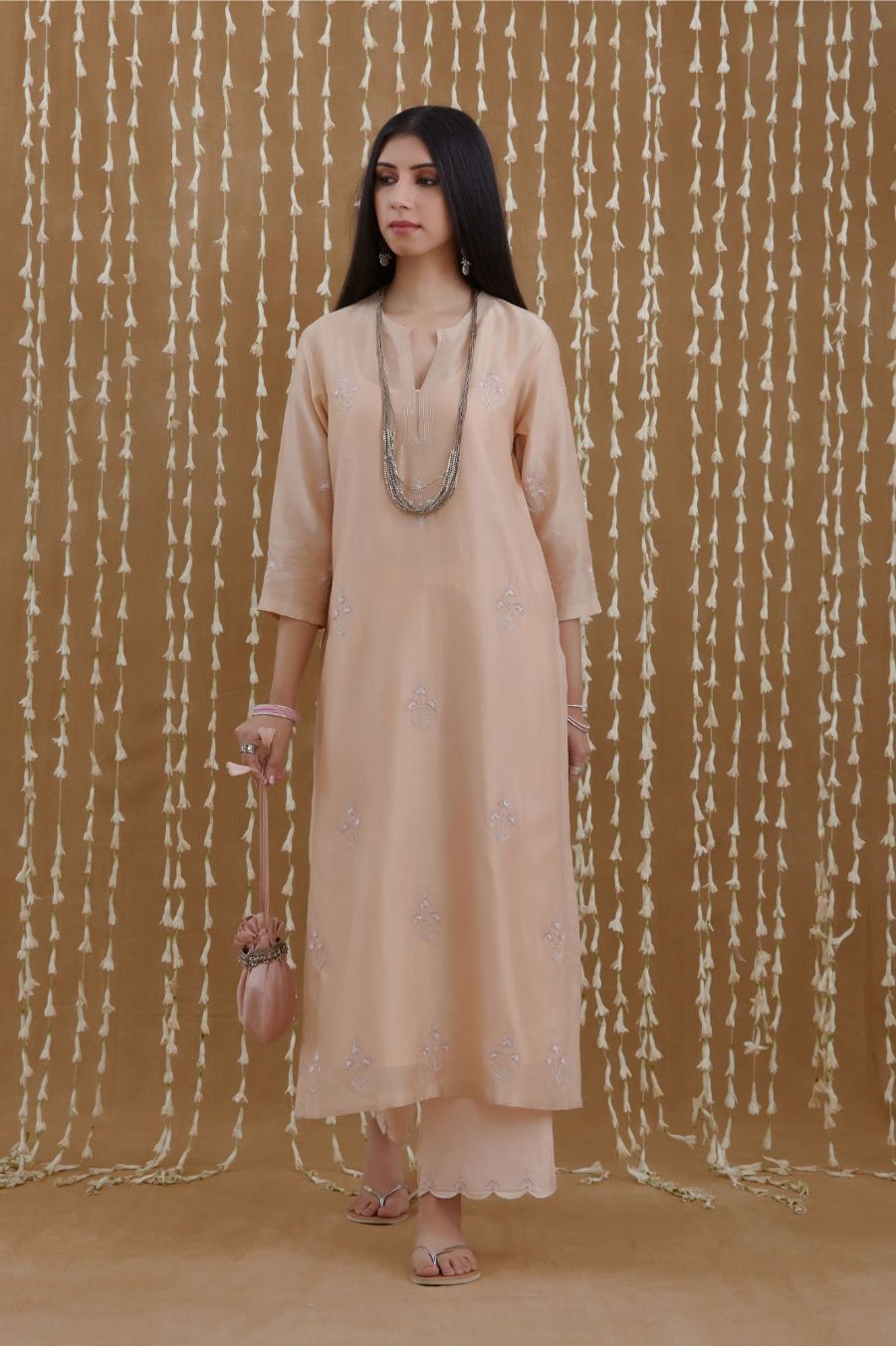 Peach staright kurta set highlighted with all-over silver zari and contrast coloured thread embroidery