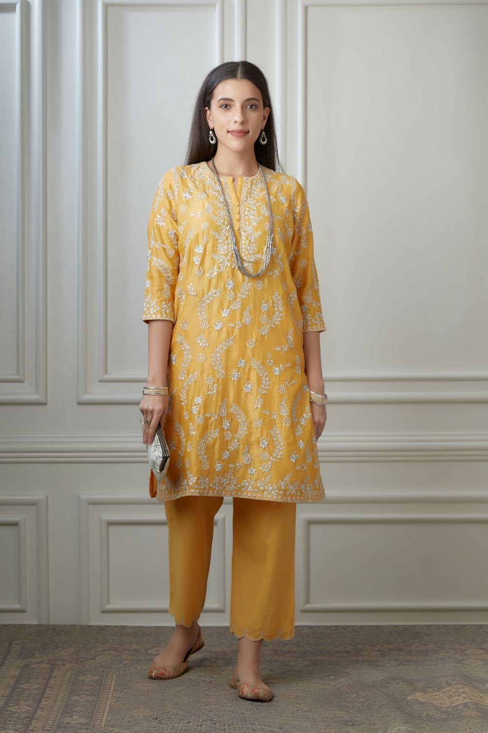 Golden yellow short kurta set highlighted with all-over silver zari embroidery