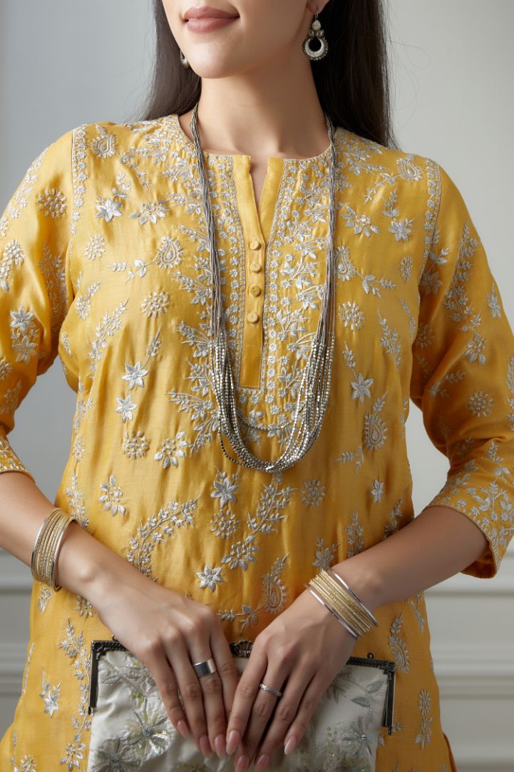 Golden yellow short kurta set highlighted with all-over silver zari embroidery