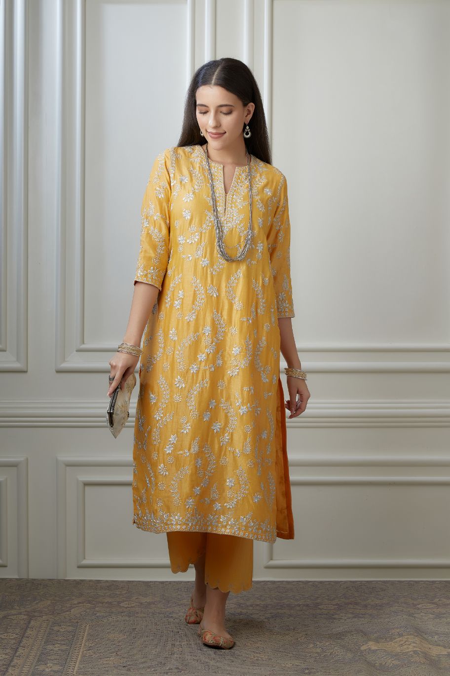 Golden yellow straight kurta set with all-over silver zari embroidery and round neck with slit in front