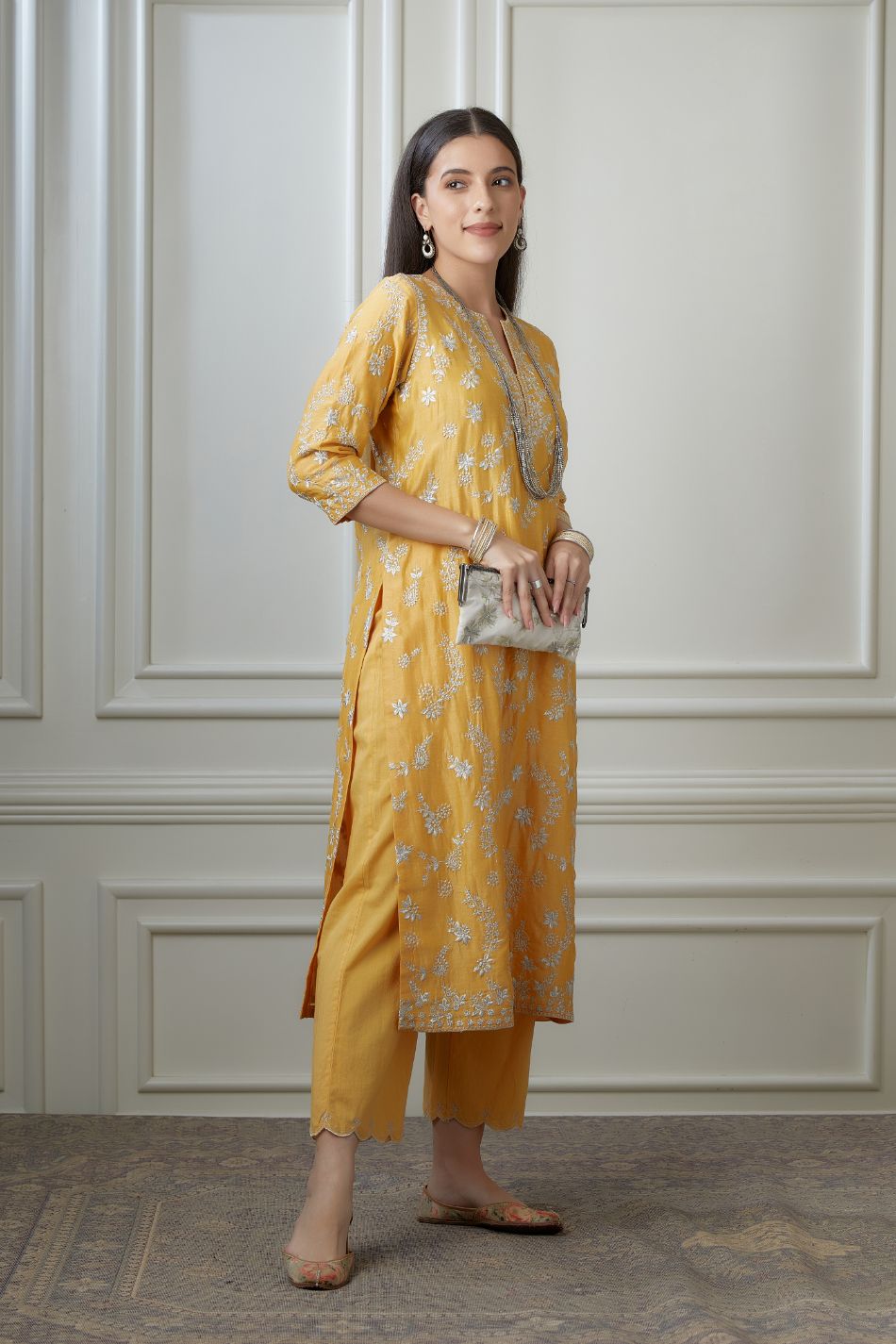 Golden yellow straight kurta set with all-over silver zari embroidery and round neck with slit in front