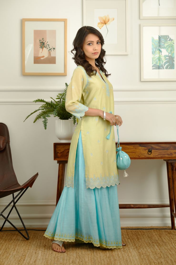 Lime green short kurta set with scalloped embroidered edges at hem and sleeves.