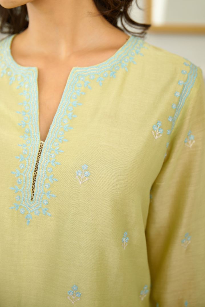 Lime green short kurta set with scalloped embroidered edges at hem and sleeves.