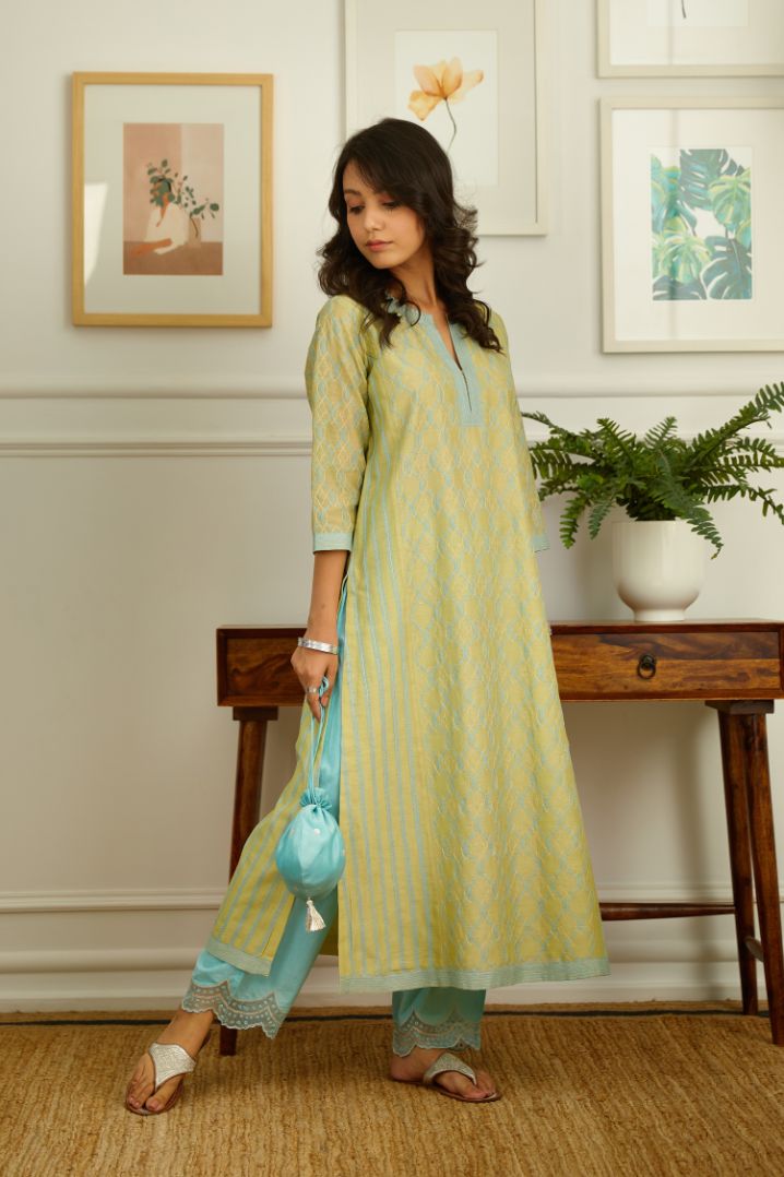 Lime green silk chanderi straight kurta set with full jaal embroidery in central panel and striped embroidered side panels.