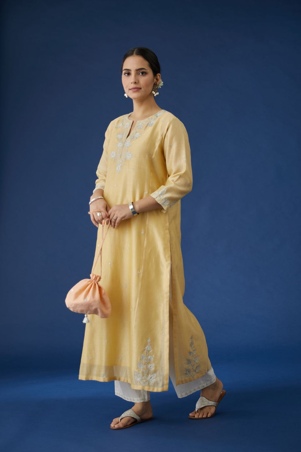 Pale yellow silk chanderi kurta set with all-over silver zari embroidery.