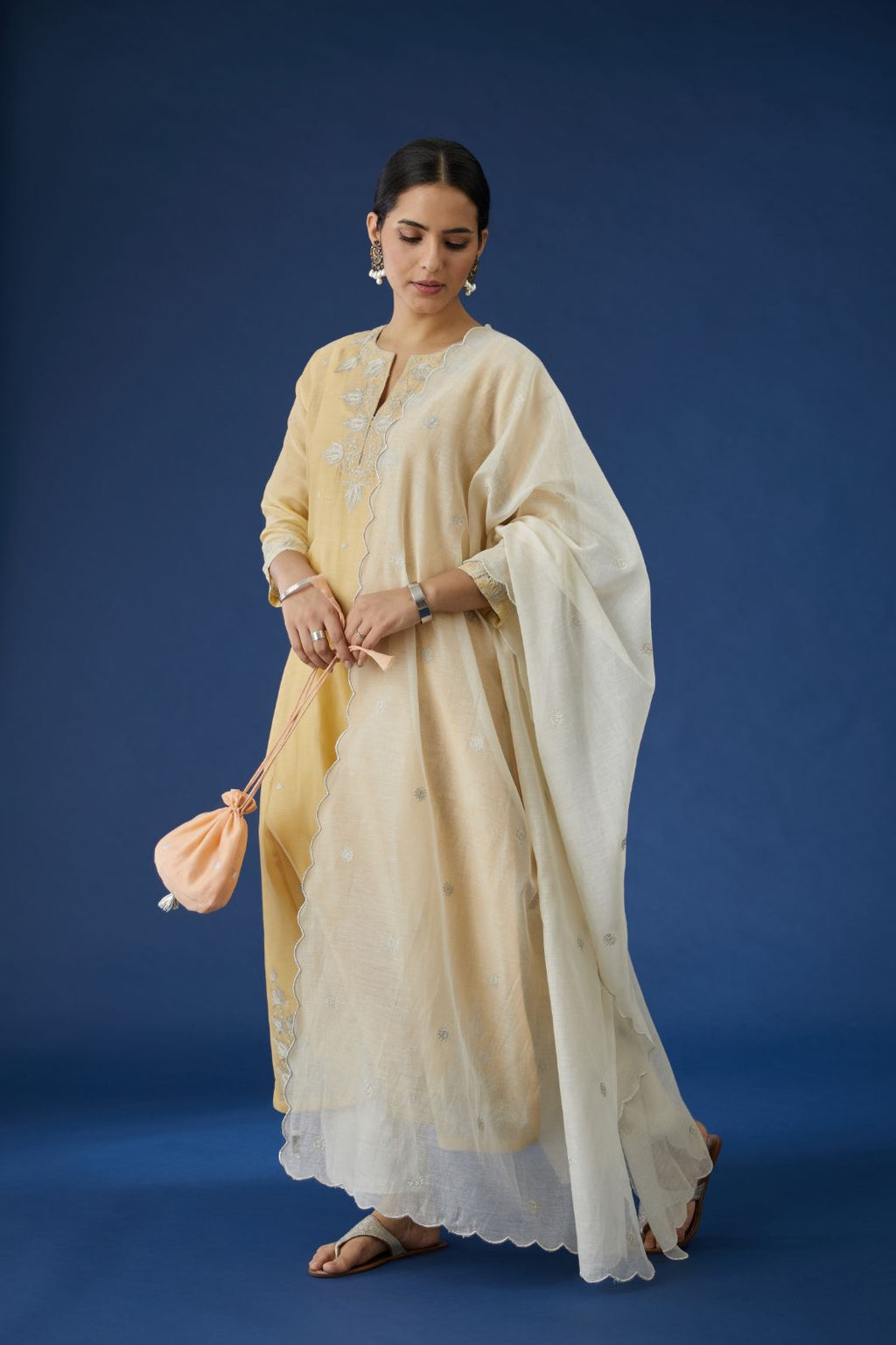 Pale yellow silk chanderi kurta set with all-over silver zari embroidery.