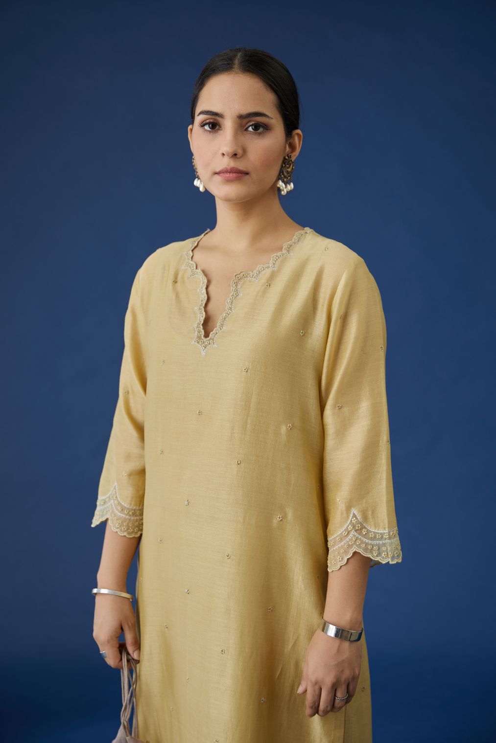 Dusty gold silk chanderi straight kurta set with scalloped hem and embroidered neckline.