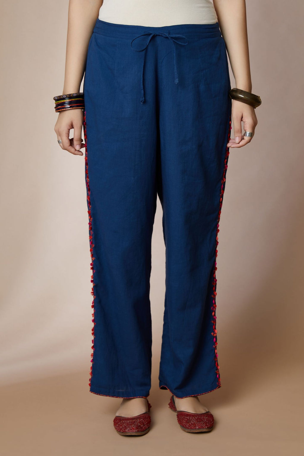 Indigo blue cotton straight pants with bird and tassel embroidery at sides
