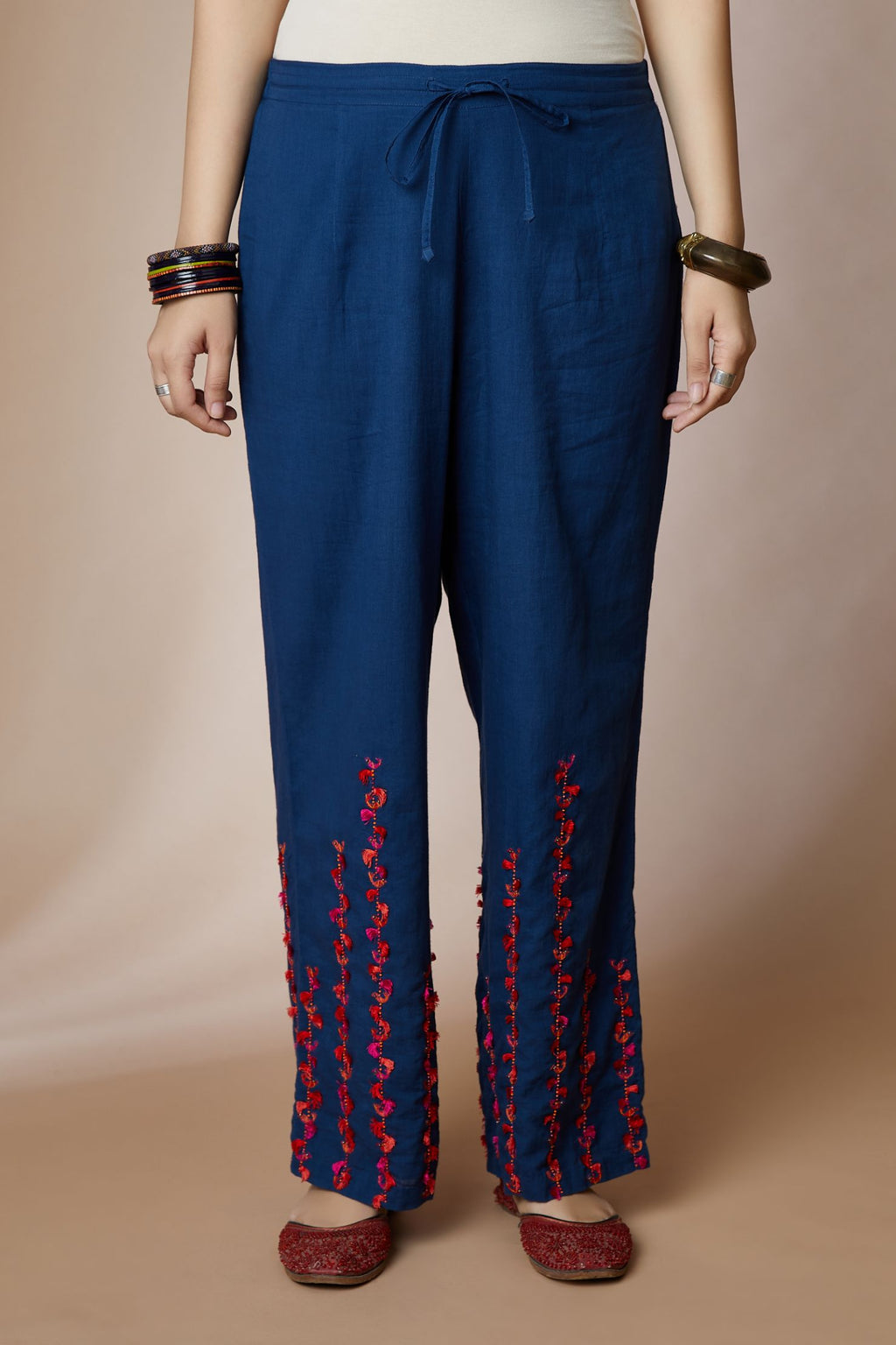 Indigo blue cotton straight pants with bird and tassel stripes at hem