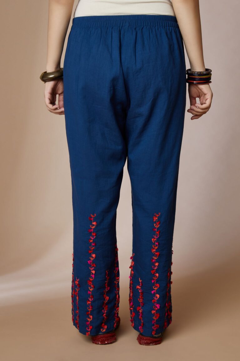 Indigo blue cotton straight pants with bird and tassel stripes at hem