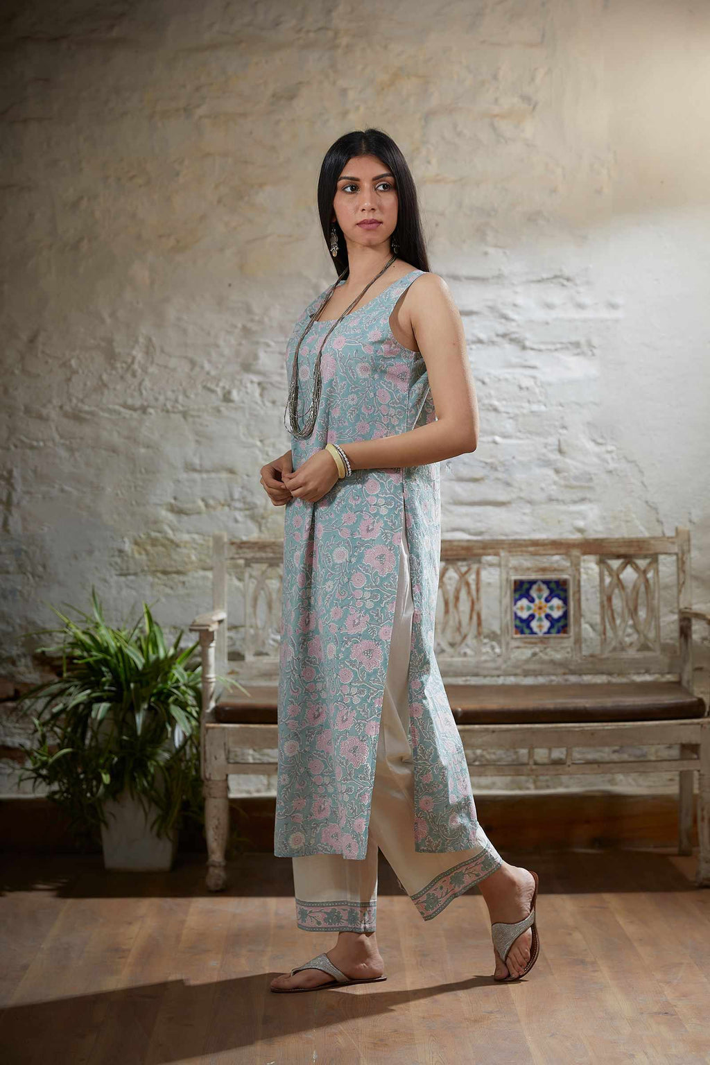 Light teal embroidered kurta set with gathered empire waist line in front and back and printed slip.
