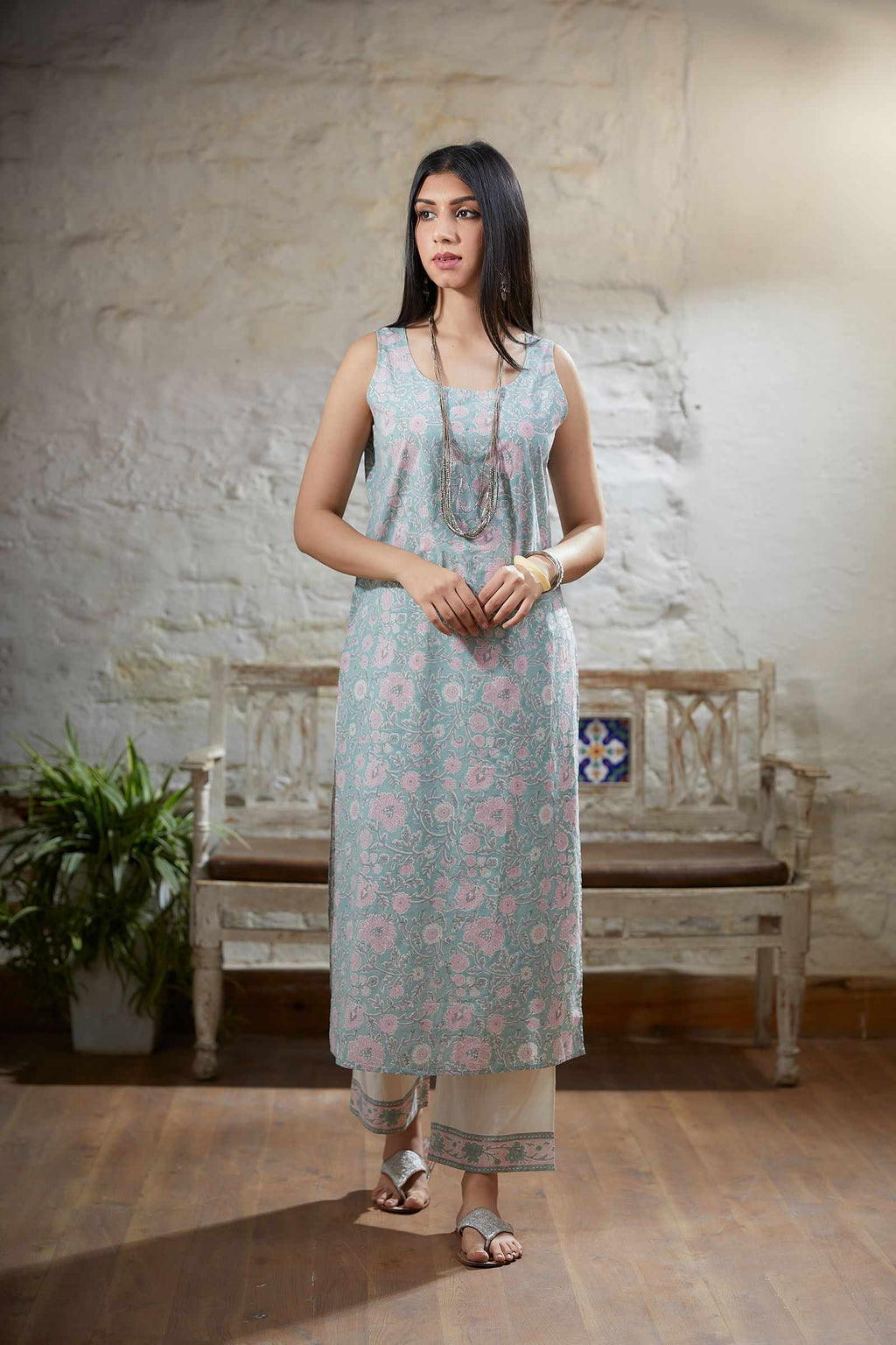 Light teal embroidered kurta set with gathered empire waist line in front and back and printed slip.