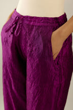 Sangria hand crushed silk straight pants with scalloped and embroidered organza at edges and detailed with a single line of sequins at hem
