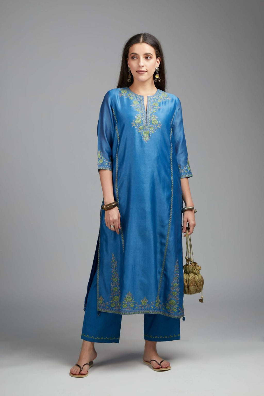 Blue straight kurta set detailed with contrast coloured embroidery at neck and side panel joint seams
