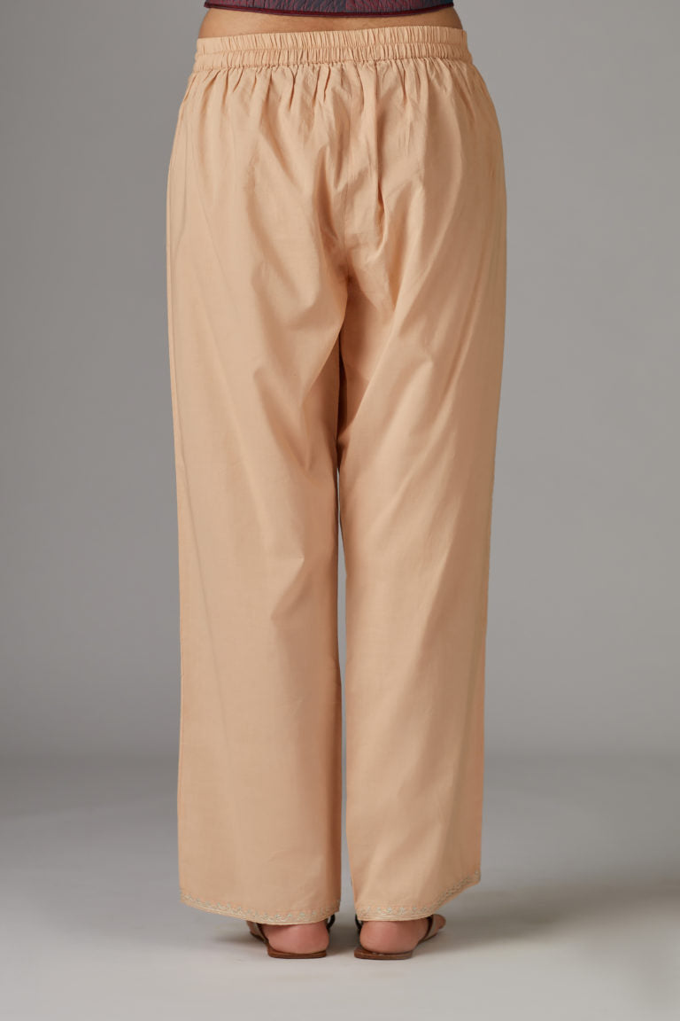 Peach cotton straight pants with aari embroidery at hem