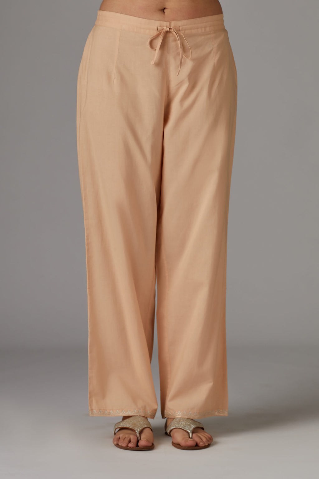 Peach cotton straight pants with aari embroidery at hem