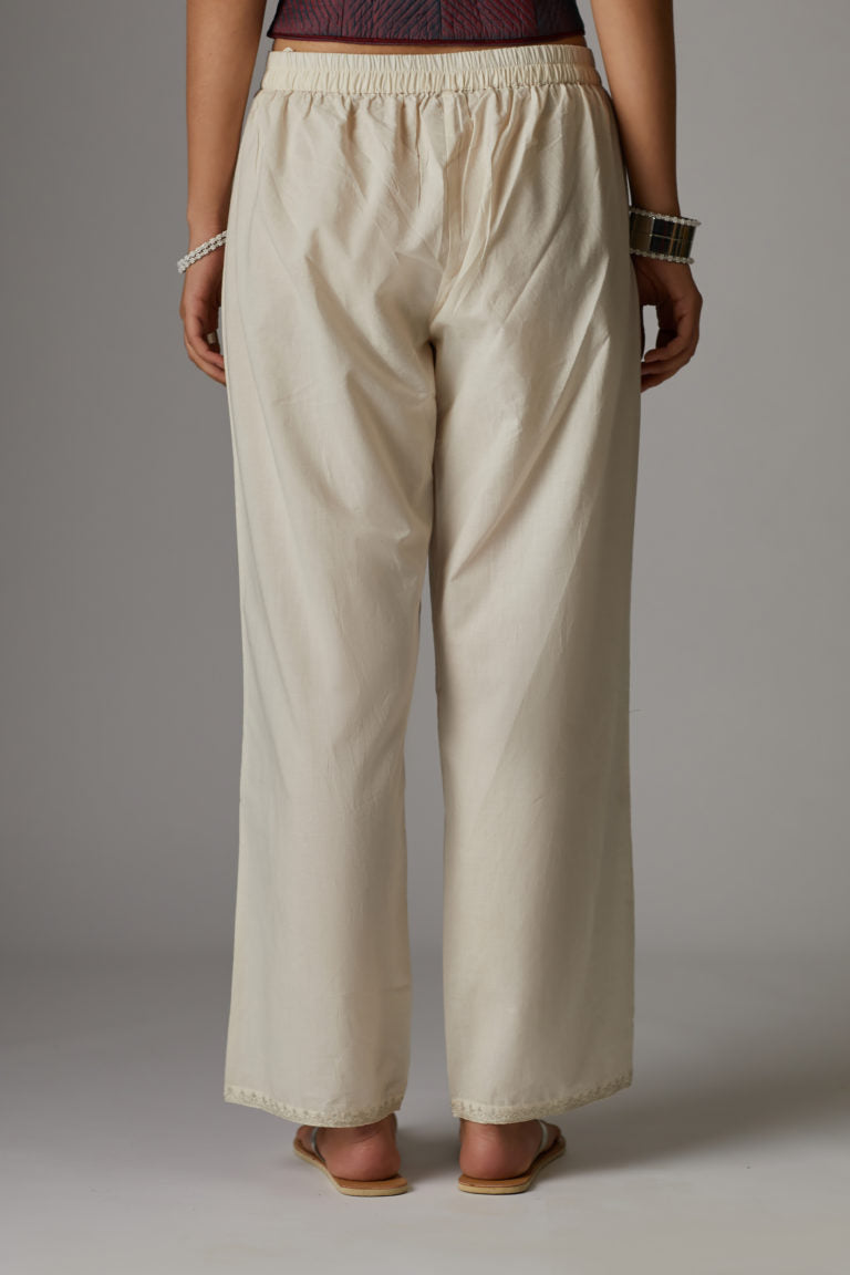 Off white cotton straight pants with aari embroidery at hem