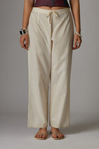 Off white cotton straight pants with aari embroidery at hem