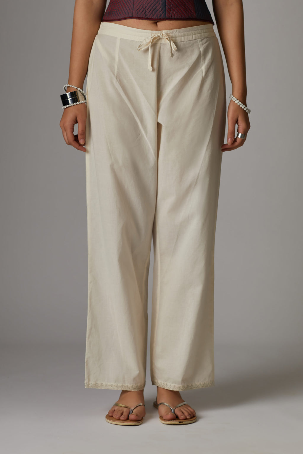 Off white cotton straight pants with aari embroidery at hem