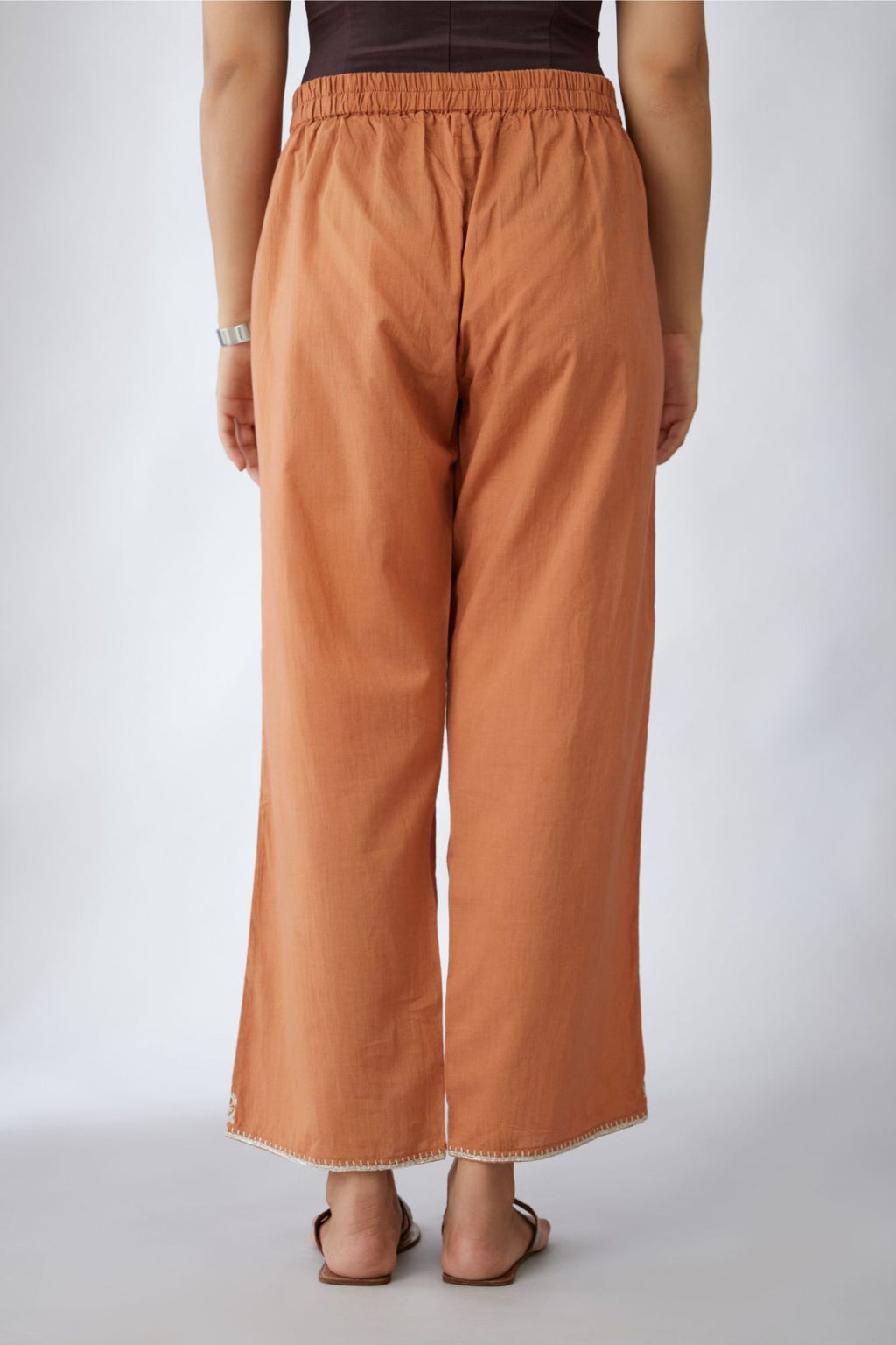 Copper cotton straight pants with silver embroidery detailing at bottom hem (Pants)