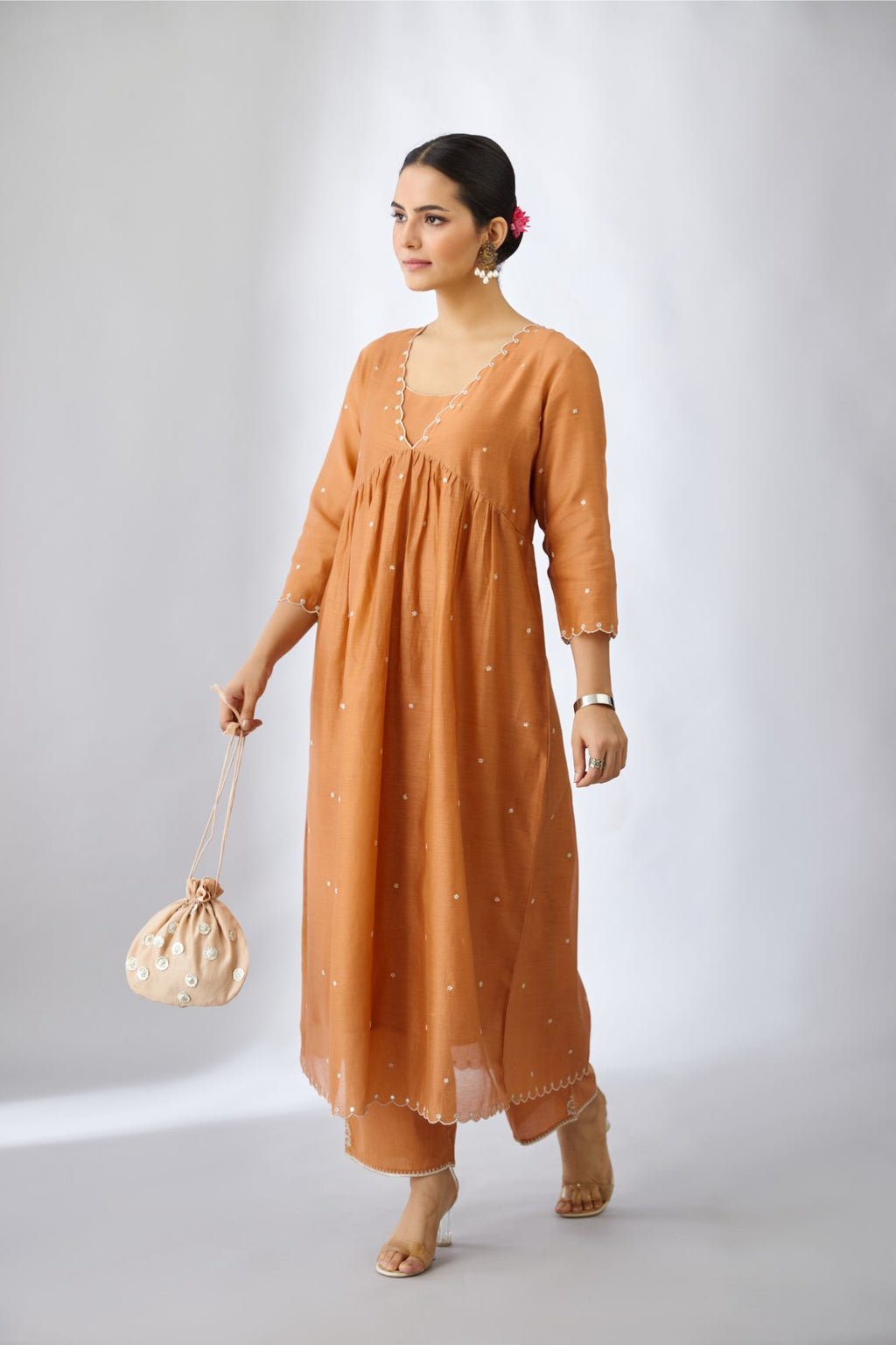 Copper silk chanderi kurta set with delicate silver zari flowers and scalloped edges highlighted with hand attached mirrors.