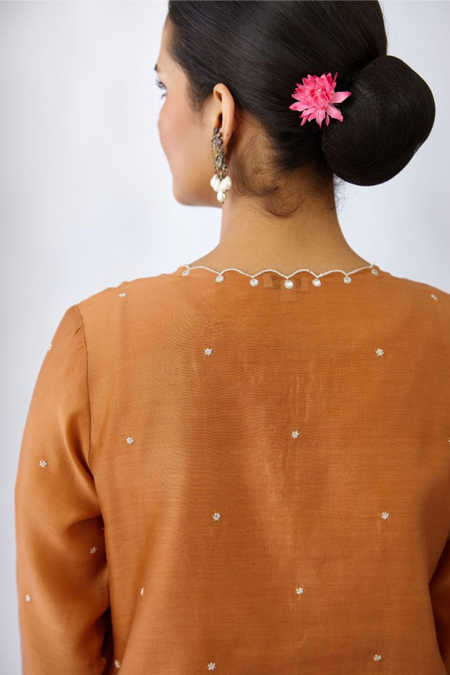 Copper silk chanderi straight kurta set with all-over delicate silver zari flowers and scalloped edges, highlighted with hand attached mirror .