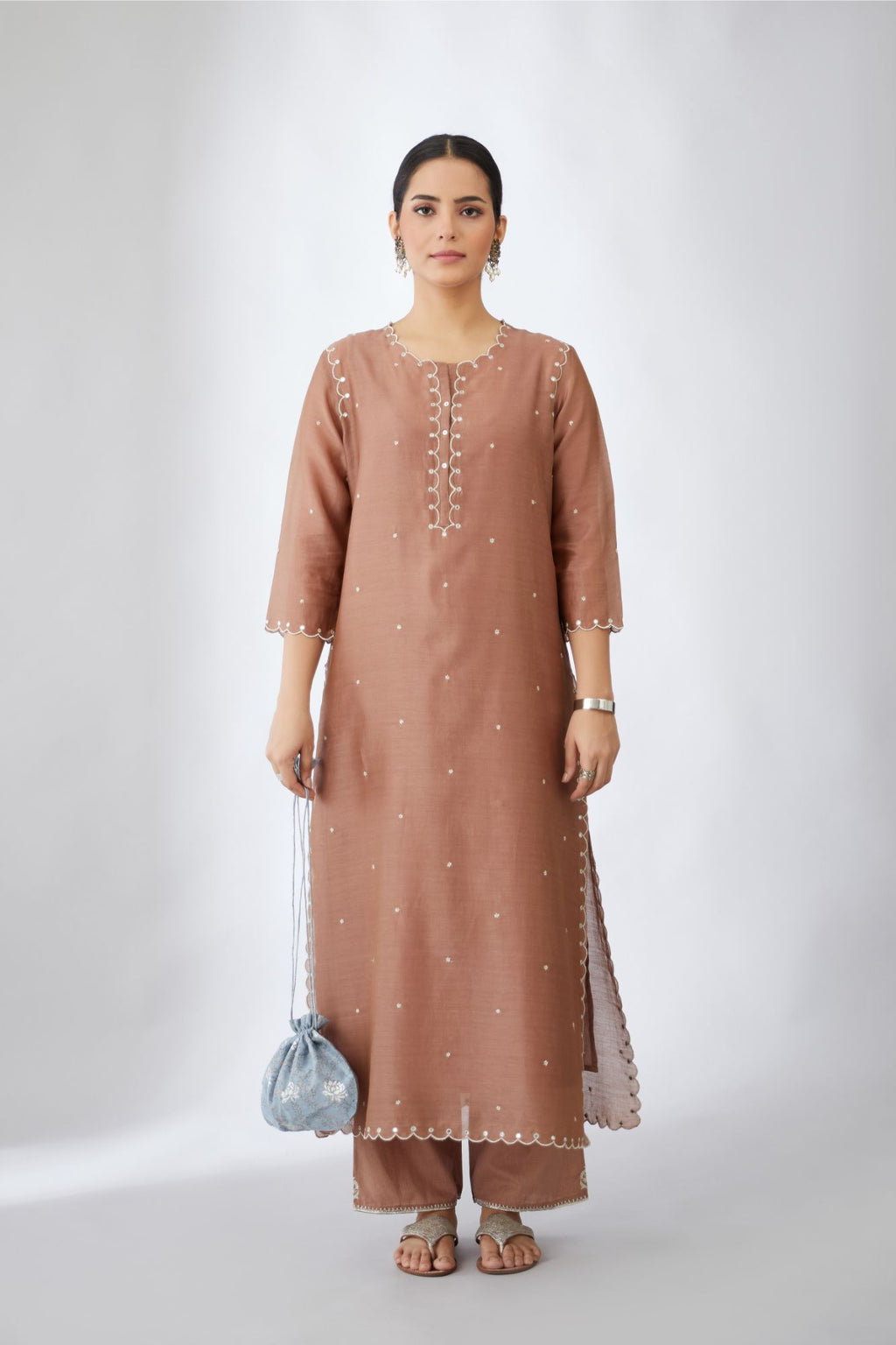 Silk chanderi straight kurta set with all-over delicate silver zari flowers and scalloped edges, highlighted with mirror hand work.