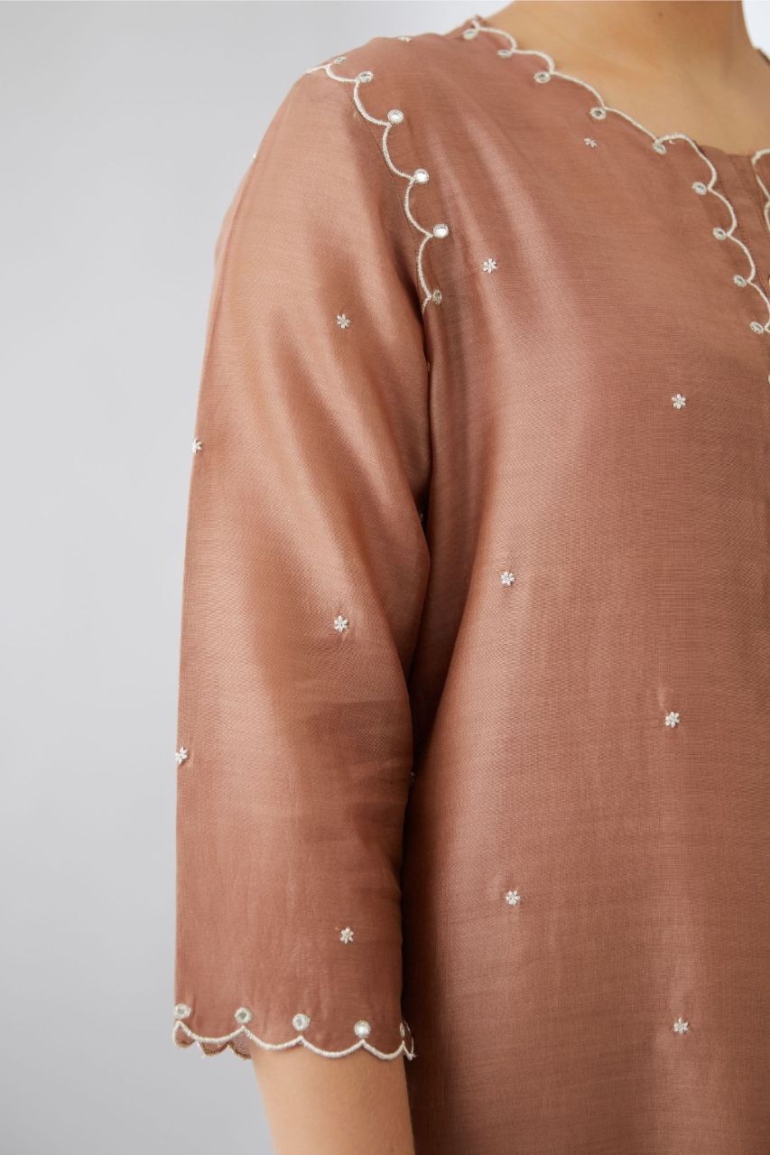 Silk chanderi straight kurta set with all-over delicate silver zari flowers and scalloped edges, highlighted with mirror hand work.