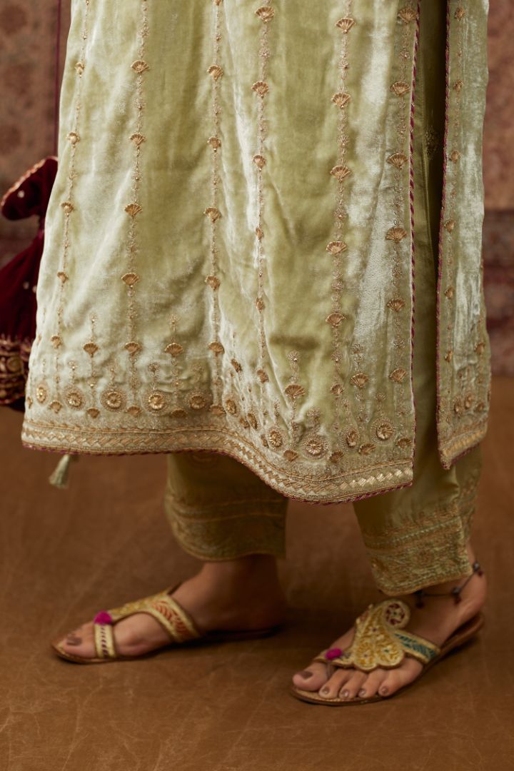 Soft green silk velvet straight kurta set with all over heavy gold gota and zari embroidery.