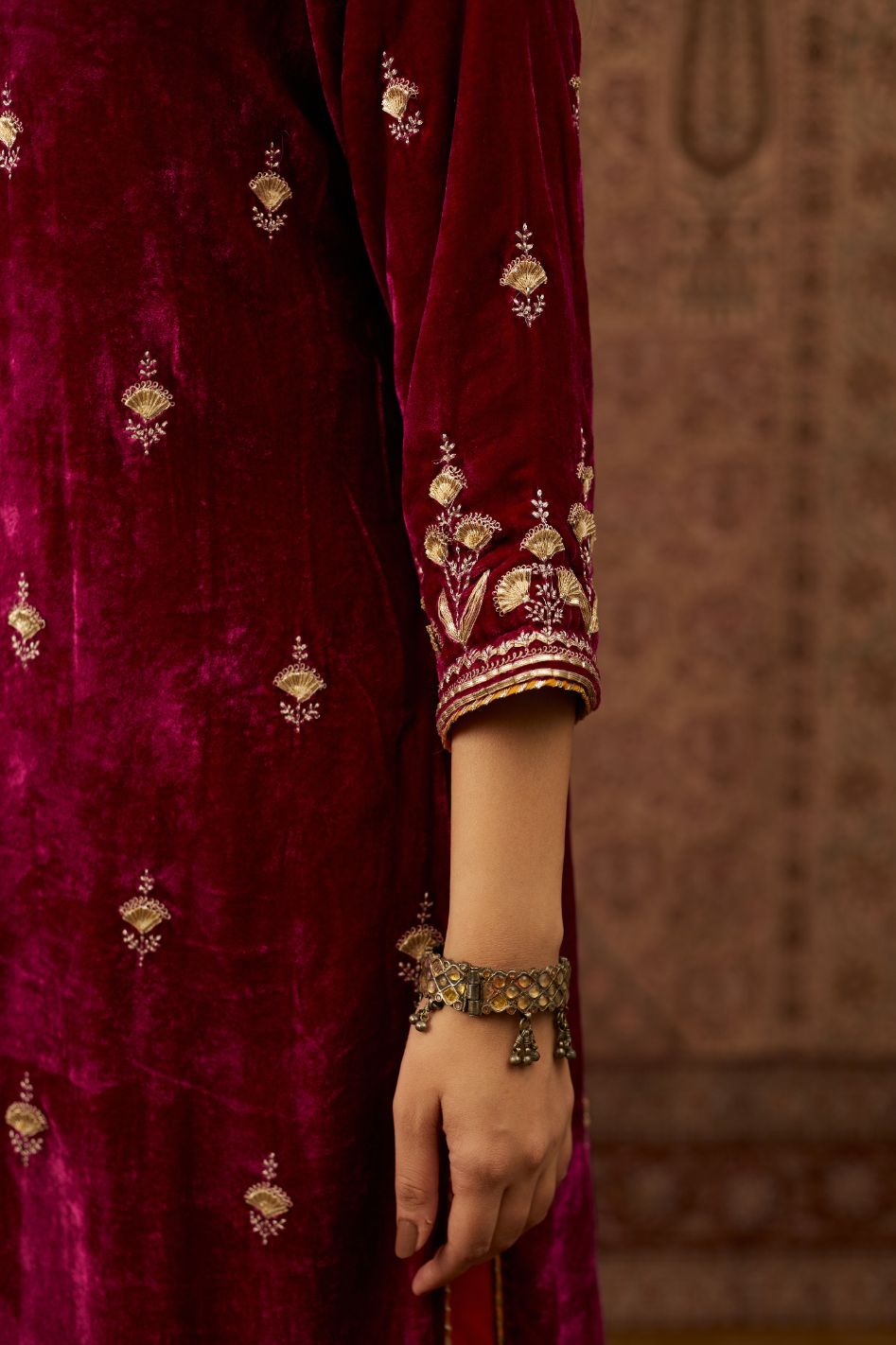 Silk velvet kurta set with round neck and all-over gota embroidery.