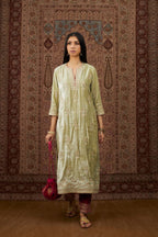 Soft green silk velvet kurta set with gold gota and zari embroidery butas and heavy borders at hem.