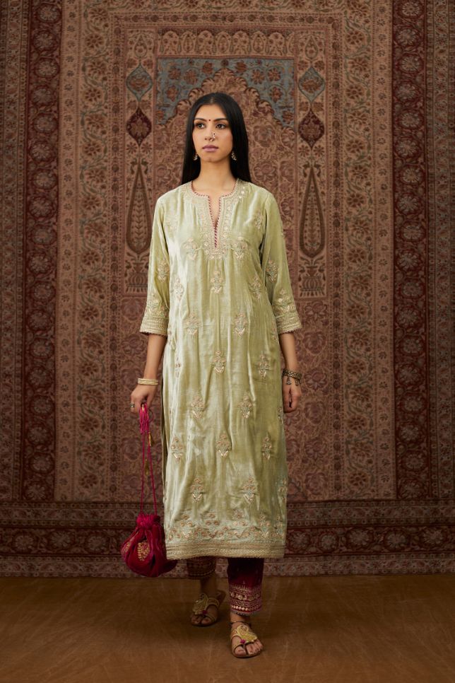 Soft green silk velvet kurta set with gold gota and zari embroidery butas and heavy borders at hem.