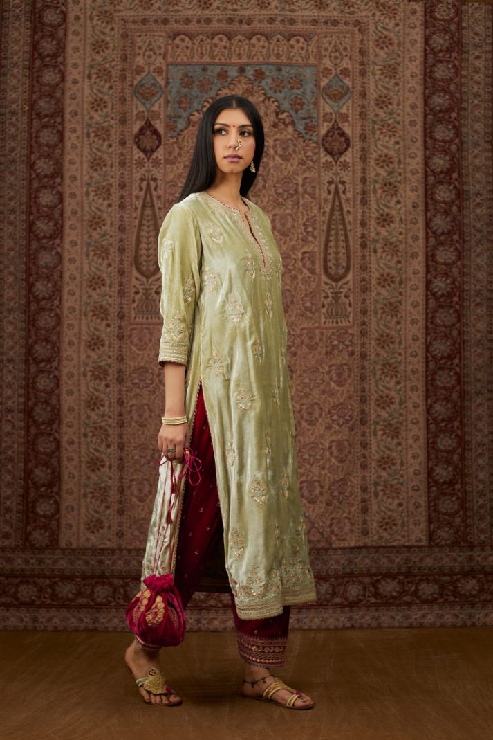 Soft green silk velvet kurta set with gold gota and zari embroidery butas and heavy borders at hem.