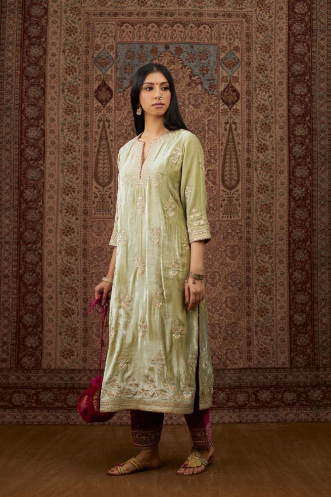 Soft green silk velvet kurta set with gold gota and zari embroidery butas and heavy borders at hem.