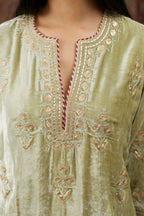 Soft green silk velvet kurta set with gold gota and zari embroidery butas and heavy borders at hem.
